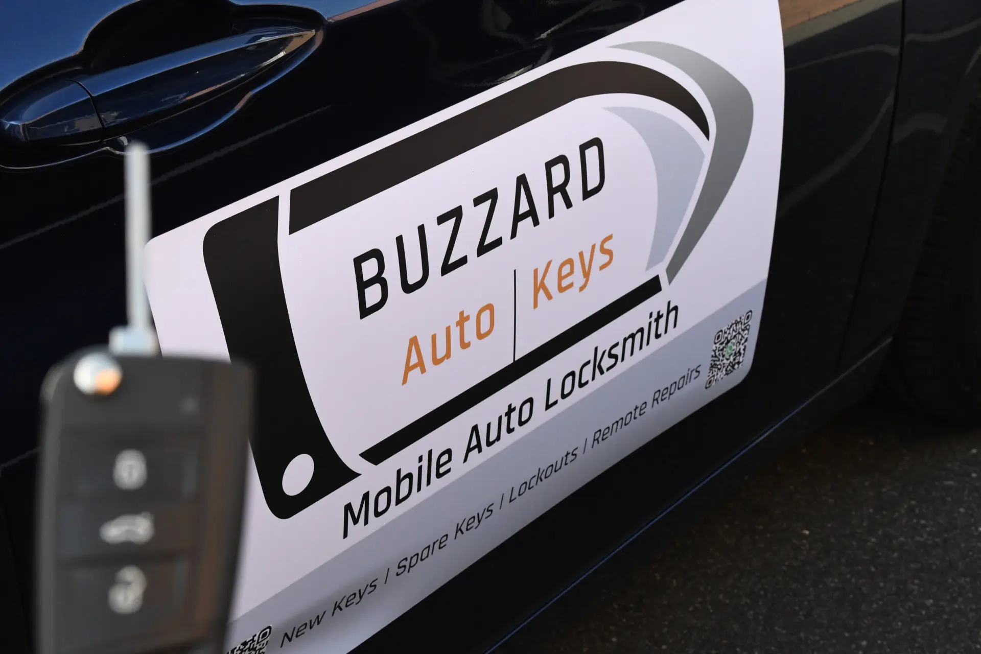 Buzzard Auto Keys sign on car with remote